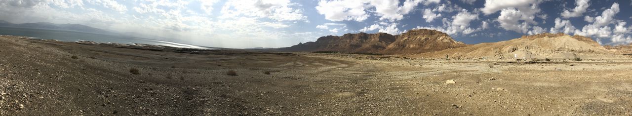 Panoramic view of arid landscape against sky