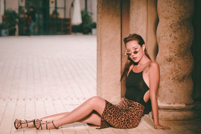 Portrait of young woman sitting outdoors