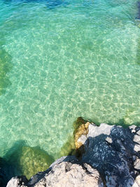 High angle view of rocks by sea