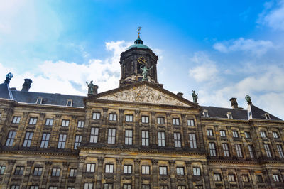 Low angle view of building against cloudy sky