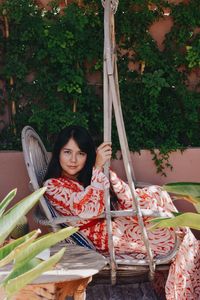 Portrait of smiling woman holding food outdoors