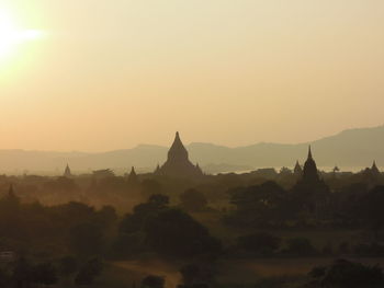 Panoramic view of temple building against sky during sunrise