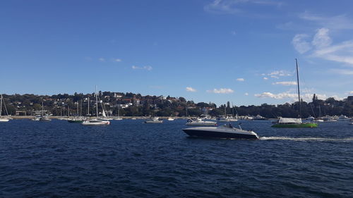 Sailboats in sea against sky