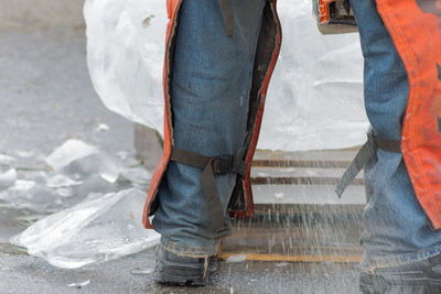 Low section of man standing at construction site