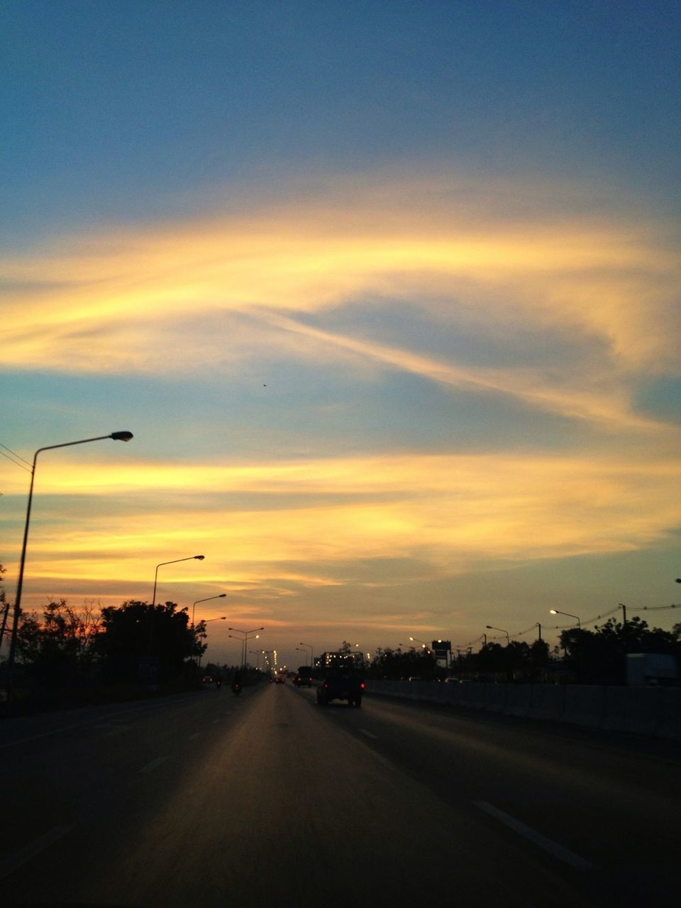 sunset, transportation, road, sky, the way forward, orange color, cloud - sky, diminishing perspective, street, car, silhouette, road marking, scenics, beauty in nature, tranquility, nature, tranquil scene, cloud, vanishing point, land vehicle