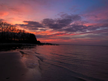 Scenic view of sea against romantic sky at sunset