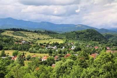 Scenic view of field and mountains against sky