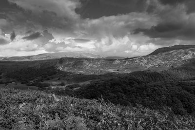 Scenic view of mountains against cloudy sky