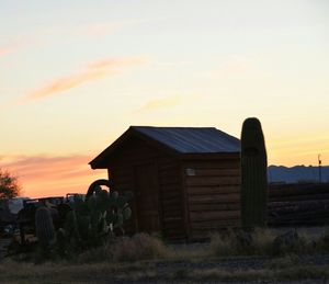 Barn on field at sunset