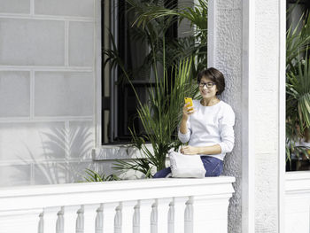 Young woman drinking water at home