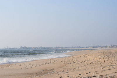 Scenic view of beach against clear sky