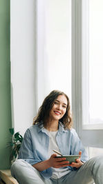 Young woman using laptop at home