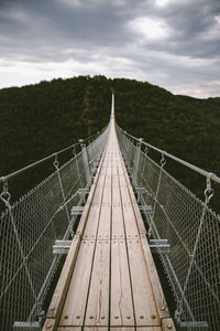 Footbridge against sky