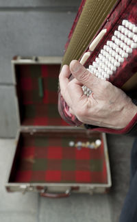 Cropped hand of man playing musical instrument