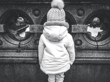 Rear view of man standing by statue