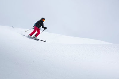 Full length of man skiing on snowcapped mountain