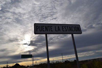 Low angle view of road sign against sky