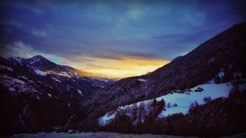 Scenic view of mountains against cloudy sky