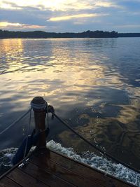 Scenic view of river against sky at sunset