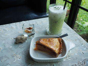 Close-up of apple pie and ice green tea on the table