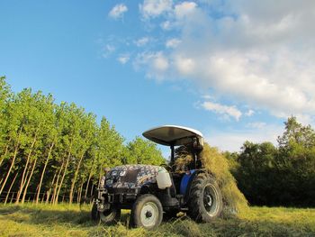 Tractor on field against sky