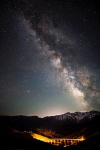 Scenic view of mountains against sky at night