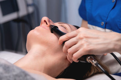 Midsection of doctor examining patient in hospital