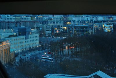 High angle view of illuminated cityscape against sky at night