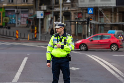 Full length of man standing on road in city