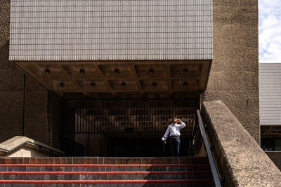 Full length of man standing on staircase of building