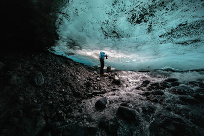 Low section of man standing glacier at glacier