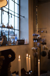 Close-up of illuminated candles on table