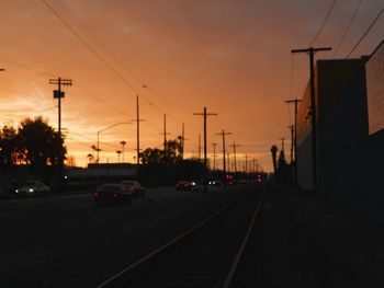 Traffic on road at sunset