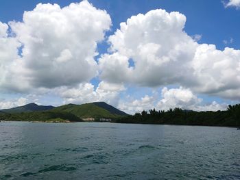 Panoramic view of sea and mountains against sky