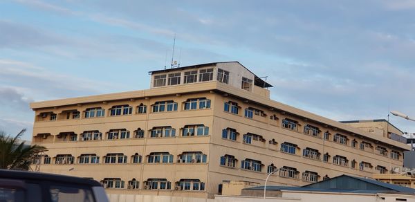 Low angle view of building against cloudy sky