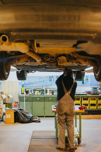 Rear view of man working at bus