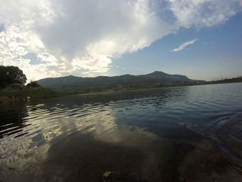 Scenic view of lake against cloudy sky