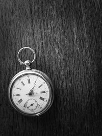 High angle view of pocket watch on table