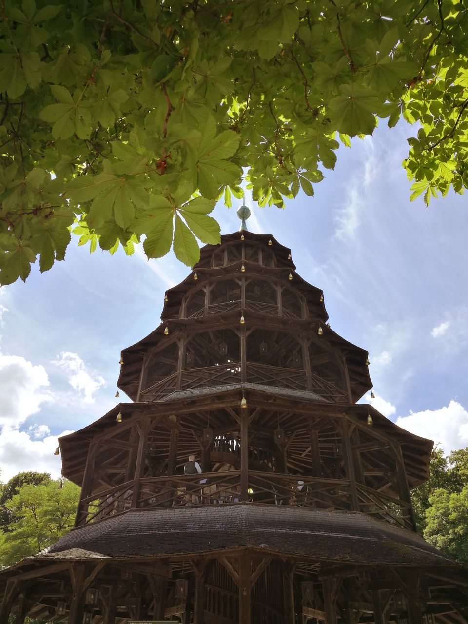 low angle view, religion, architecture, place of worship, spirituality, built structure, tree, building exterior, sky, history, cloud - sky, day, outdoors, travel destinations, no people, ancient, branch, ancient civilization