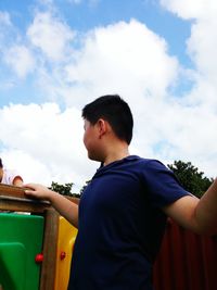 Low angle view of man standing against sky