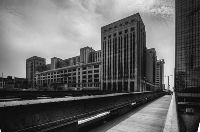 Buildings in city against cloudy sky