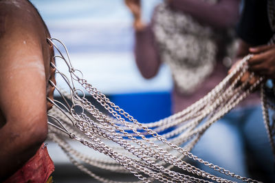 Hook and chains pierced on body during thaipusam