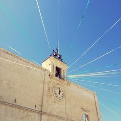 Low angle view of building against clear blue sky