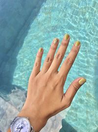 High angle view of woman hand in swimming pool