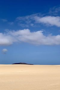 Scenic view of desert against blue sky