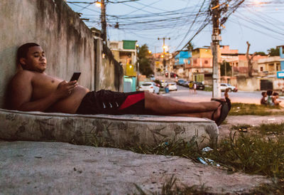 Young man using mobile phone outdoors