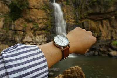 Cropped hand of person holding navigational compass