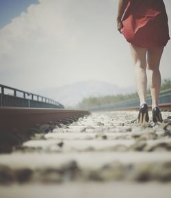 Low section of man walking on road