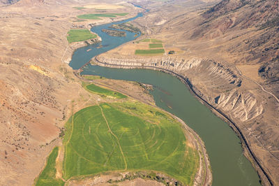 Vertical view surface of river among the mountains. aerial photo from drone. calm screensaver.