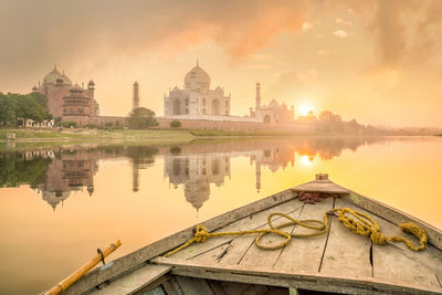 Reflection of temple in lake at sunset